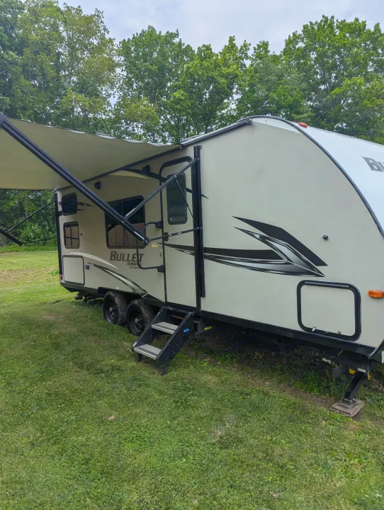 Experience outdoor adventures with this spacious travel trailer. This RV rental, complete with an extended awning and steps, is ready for your next trip.. Keystone RV Bullet Crossfire 2020