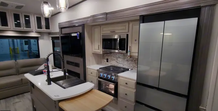 Modern RV rental with a sleek kitchen featuring an island, full appliances, and comfortable living area.. Forest River 3370RLS 2024