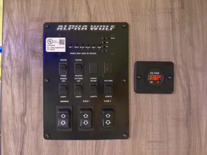 RV rental control panel for Alpha Wolf RV showing battery/tank levels, lights, slides, awning switches, and 13.21V voltmeter.. Forest River Cherokee Alpha Wolf 2020