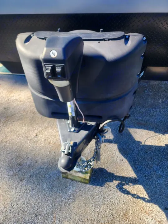 Front of an RV rental, showing its black propane tank cover and electric tongue jack for easy setup and leveling.. Forest River Cherokee Grey Wolf 2022