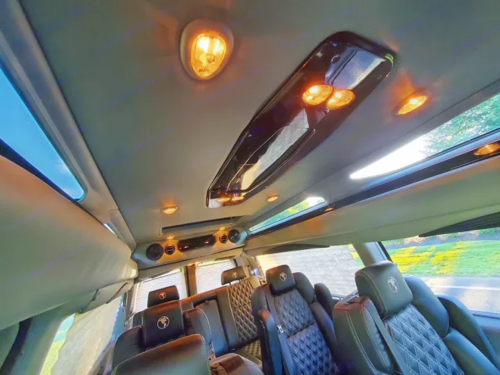Experience a luxury RV rental's interior! Plush black quilted leather seats, bright ambient lighting, & large windows fill this custom van.. Chevy Luxury Splinter Express Express Conversion Van 2024