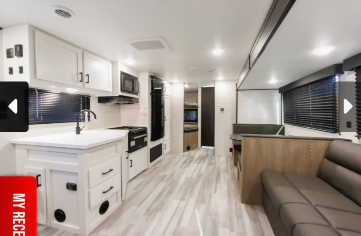Spacious RV rental interior with a bright kitchen, dinette booth, and comfortable sofa area.. Jayco Jay Flight SLX 2025