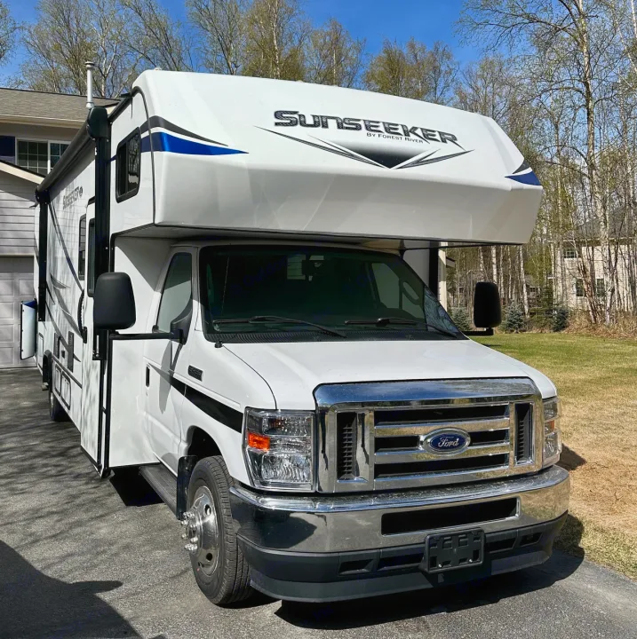 A white Sunseeker RV rental is parked on a sunny driveway, ready for road trips and camping adventures.. Forest River Sunseeker LE 2021