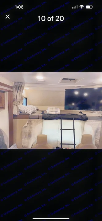 Spacious RV rental cab-over bunk with TV, bedding, and ladder for comfortable sleeping. Ideal for family adventures.. Forest River Sunseeker LE 2019
