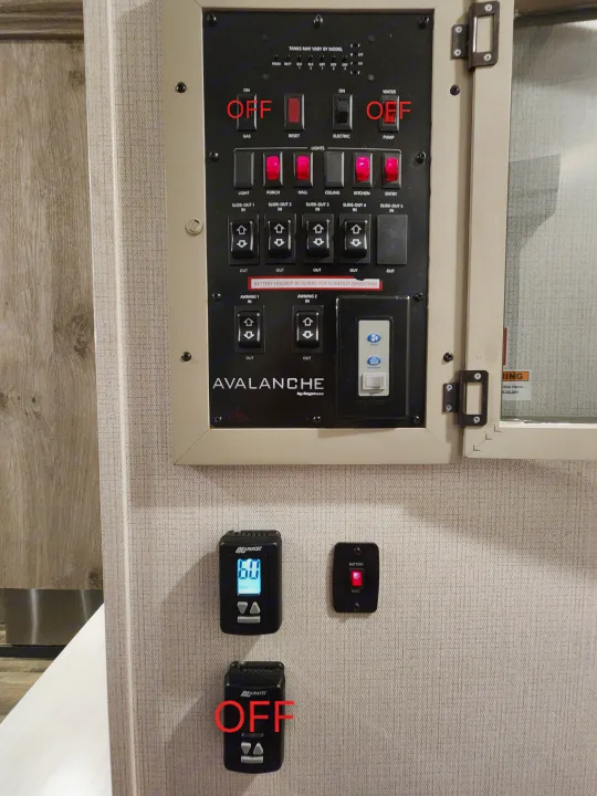RV rental main control panel displays switches for lighting (some on), water heater, pump, and climate controls.. Keystone RV Avalanche 2023