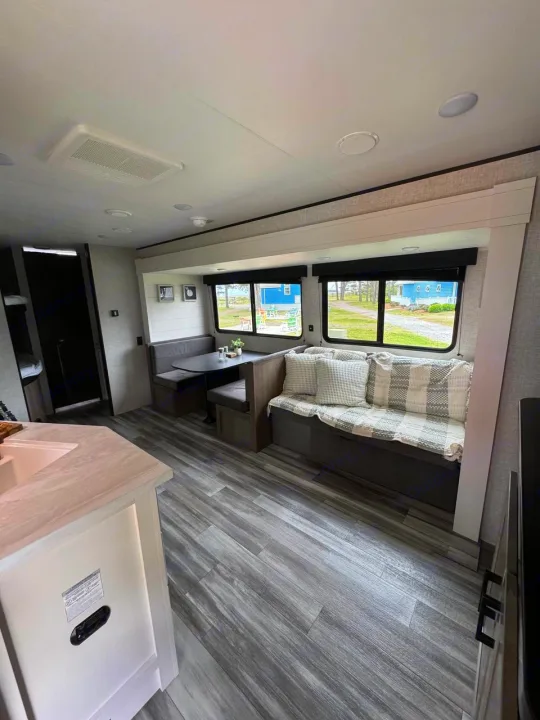 Explore this cozy RV rental interior! Features a comfortable living area, dining booth, and modern kitchen.. Jayco JAY Flight SLX 261BHS 2025