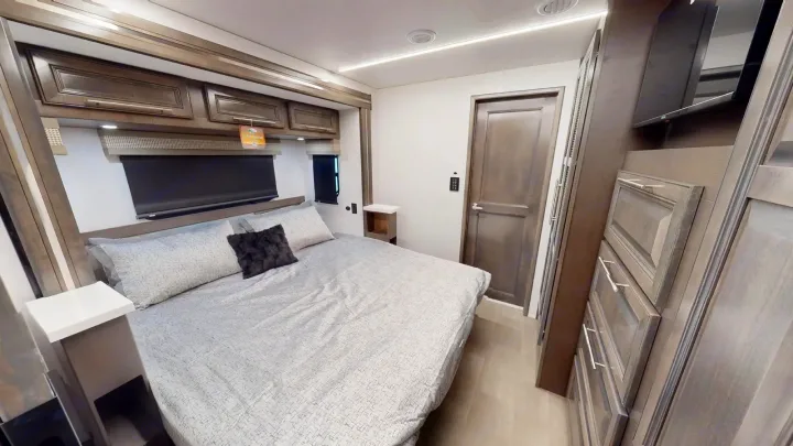 Spacious RV rental bedroom with comfortable bed, ample storage, and TV. Your adventure awaits!. Georgetown GT7 2022