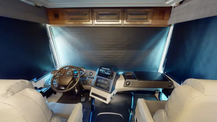 RV rental: Modern RV cab interior with steering wheel, dashboard, light seats, and dark windshield shades.. Georgetown GT7 2022