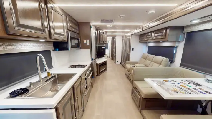 Spacious luxury RV rental interior: modern kitchen, comfortable living area, and dining space for your next adventure.. Georgetown GT7 2022