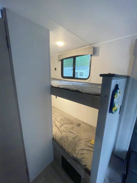 Cozy RV rental interior with comfortable bunk beds, perfect for family travel or camping adventures.. Forest River Coachmen Clipper 2024