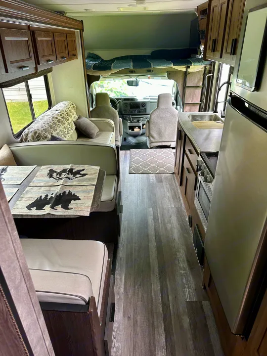 Step inside this RV rental! Features a comfy dinette, full kitchen, and overhead bunk for your road trip.. Forest River Sunseeker LE 2021