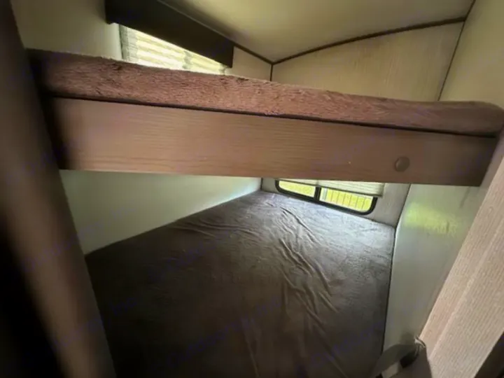 RV rental bunk beds provide comfortable sleeping space. Features an upper bunk and lower bed with a window.. Cruiser RV Shadow Cruiser 2019