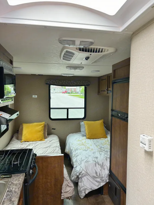 Experience this rv rental! Cozy interior with twin beds, a full kitchen, microwave, and fridge, ready for your next road trip.. Crossroads Z-1 2017