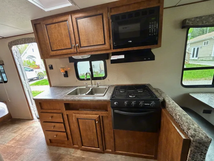 RV rental: well-equipped kitchen featuring microwave, stove, double sink, and cozy dinette.. Crossroads Z-1 2017