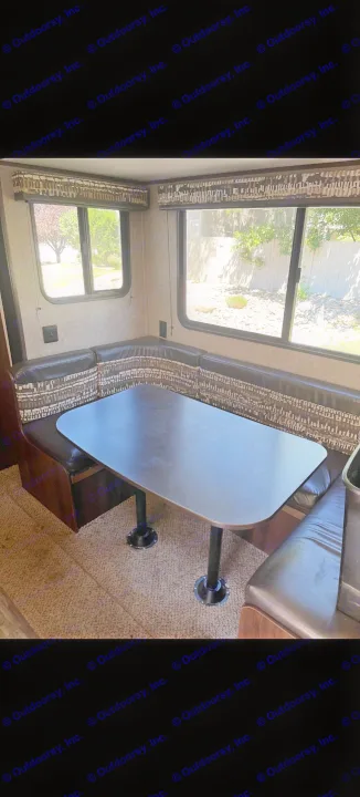 Spacious RV rental dinette featuring U-shaped booth seating, a dark table, and large windows for scenic views.. Jayco Jay Flight 2018