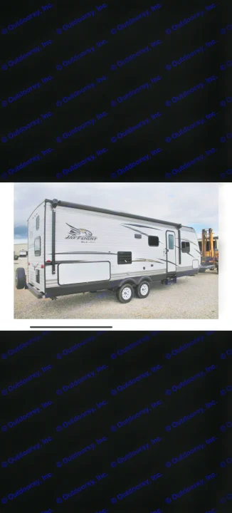 White Jayco Jay Flight SLX recreational vehicle (RV rental), a travel trailer with an awning, spare tire, and dual axles.. Jayco Jay Flight 2018