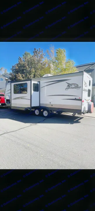 Jayco travel trailer RV rental parked on a sunny street with slide-out extended. Perfect for your next trip.. Jayco Jay Flight 2018