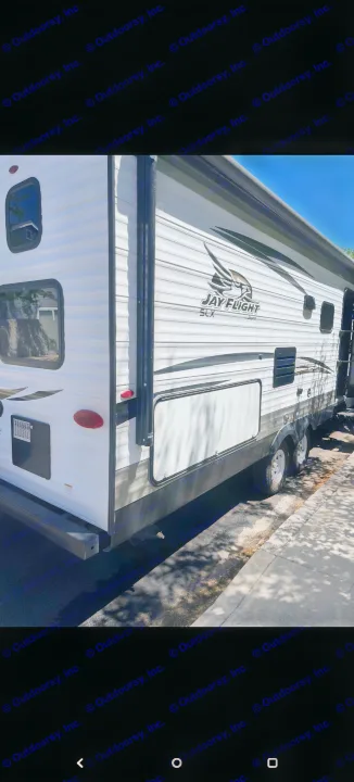 Bright white Jay Flight SLX travel trailer, side view showing windows & storage. Ideal RV rental for your next trip.. Jayco Jay Flight 2018
