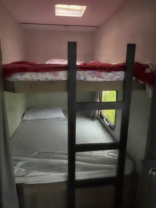 RV rental bunk beds: cozy sleeping setup with a skylight & window.. Gulf Stream Ameri-Lite 2022
