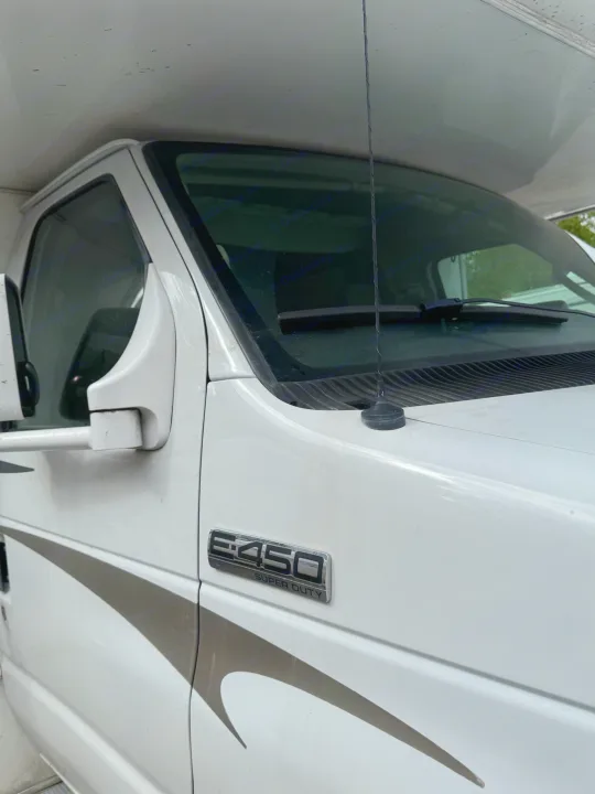 Close-up of a white Ford E-450 Super Duty RV, ready for your next RV rental adventure.. Coachmen Freelander 2014