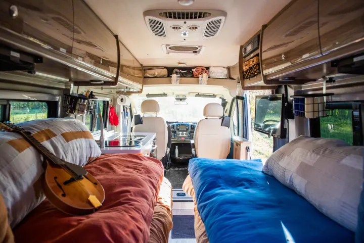 Spacious RV rental interior with beds (one with mandolin), kitchen, & driver's cabin view. Ready for your adventure.. Winnebago Travato 2020
