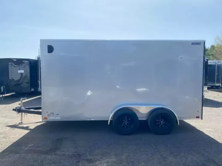 Bright silver enclosed cargo trailer, suitable for an rv rental related haul. Dual-axle, towable utility.. ITI Cargo 7X14 2025