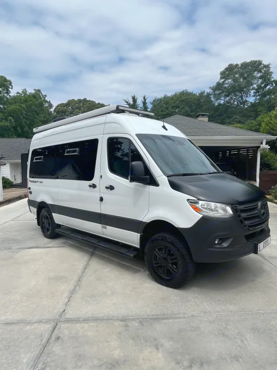 Sleek white Mercedes-Benz Sprinter "Tranquility 4x4" camper van, perfect for RV rental adventures.. Thor Tranquility 2023