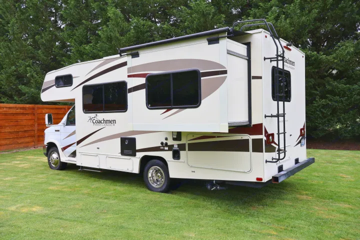 White and brown Coachmen Freelander Class C RV with slide-out extended, parked on green grass. Book your RV rental today!. Other Freelander 2016