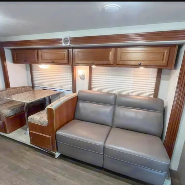 This RV rental's inviting interior features a comfortable dinette, plush sofa, and wooden overhead cabinets for home-like comfort.. Tioga Tioga Motorhome 2009