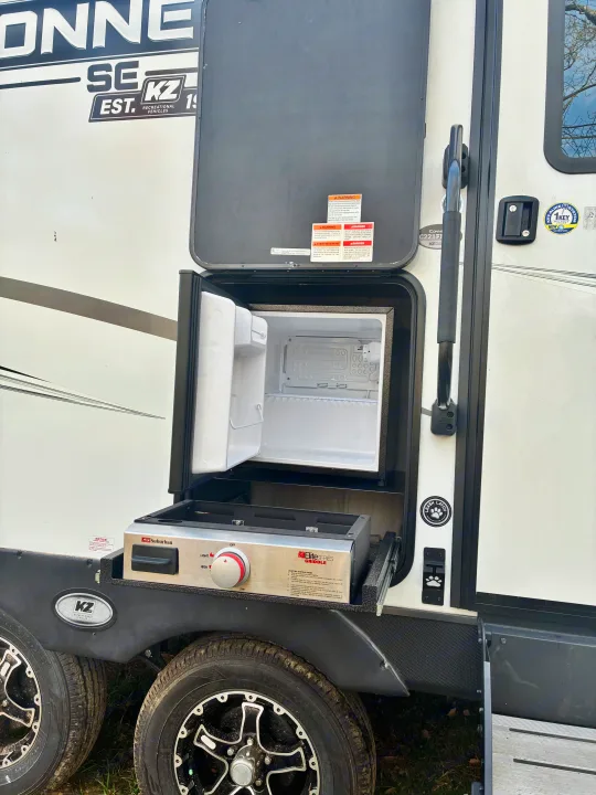 This RV rental boasts a functional outdoor kitchen, complete with a built-in mini-fridge and a pull-out griddle.. KZ Connect SE 2024