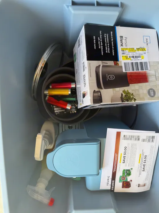 RV rental prep: A storage bin holds a blender, Keurig, flashlights, and cleaning supplies for travel.. Heartland Pioneer 2025