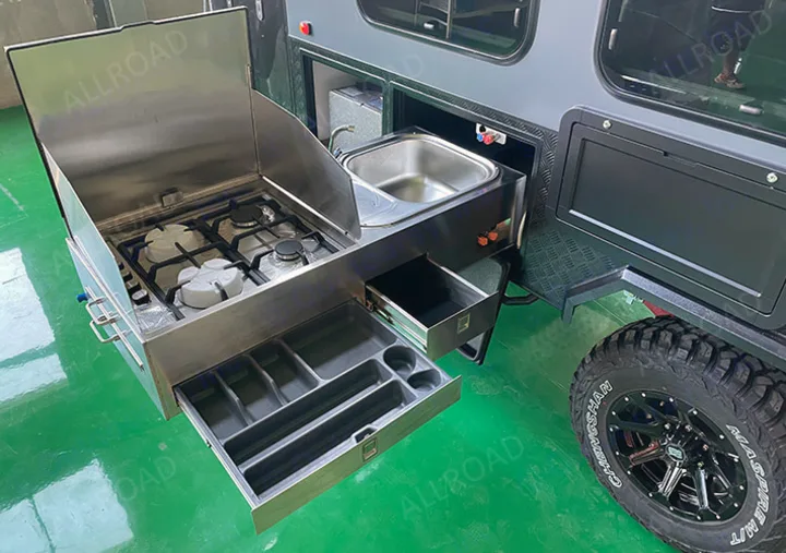 RV rental camper with a slide-out stainless steel outdoor kitchen: 3-burner gas stove, sink, and utensil drawers. Perfect for camping!. Zoomies Campers Eagle’s Nest 2025