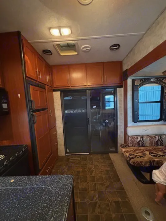 RV rental: Bright interior featuring a full kitchen, ample storage, and a comfy dining booth for your travels.. Keystone RV Fuzion Toy Hauler 2009