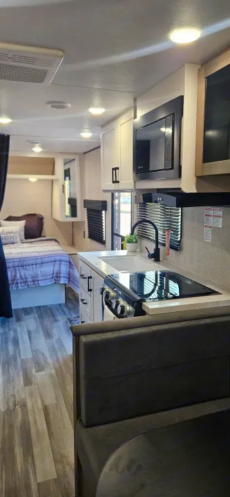 Spacious RV rental interior: modern kitchen, comfy bedroom, dining area. Your next road trip awaits!. Jayco Jay Flight SLX 210 QB 2025