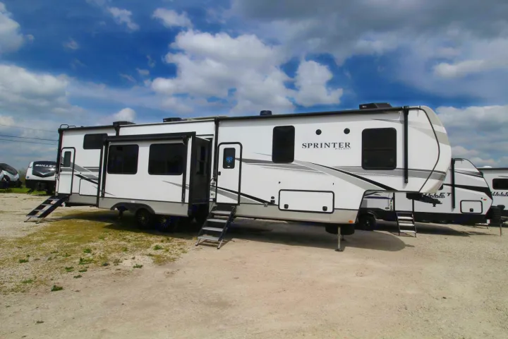 White Sprinter RV, ready for rv rental adventures! Modern travel trailer with slide-outs and deployed steps parked outdoors.. Keystone Sprinter Wide Body 2025