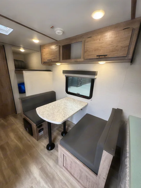 RV rental: Functional dinette, overhead storage, and bunk beds in this modern, light-filled interior.. Gulf Stream Coach Enlighten 17bh 2025
