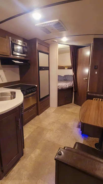 Spacious RV rental interior featuring kitchen, dining, and bunk beds. Bright and ready for adventure!. Crossroads RV Sunset Trail Super Lite 2018