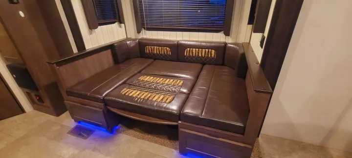 RV rental interior featuring a brown leatherette sofa/sleeper with blue LED accent lighting, perfect for a cozy stay.. Crossroads RV Sunset Trail Super Lite 2018