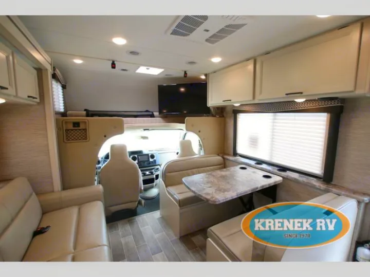 Discover this well-appointed RV rental interior: living area, dining booth, and driver's cockpit. Ideal for travel.. Thor Chateau 2022