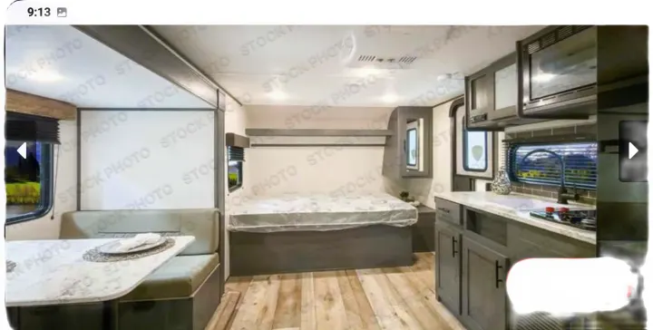 Spacious RV rental interior featuring a bright dinette, comfortable bed, and functional kitchen. Ideal for road trips!. Forest River ASPEN TRAIL 2024