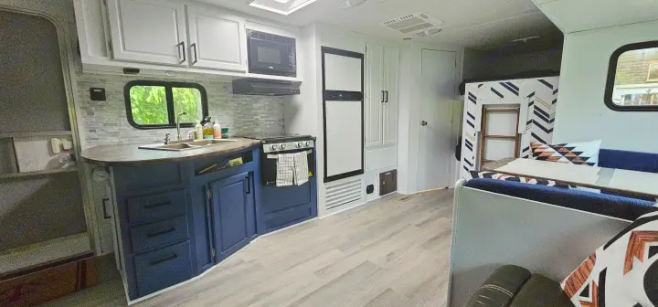 This bright RV rental boasts a modern kitchen, dining area with seating, and a playful bunk bed zone.. Crossroads RV Z-1 2015