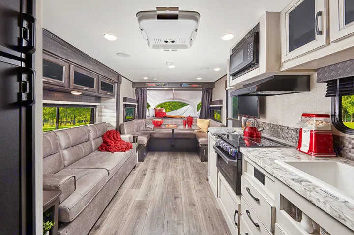 Comfortable RV rental interior featuring a spacious living area, U-dinette, and a full, well-equipped kitchen.. Jayco Jay Feather 2021