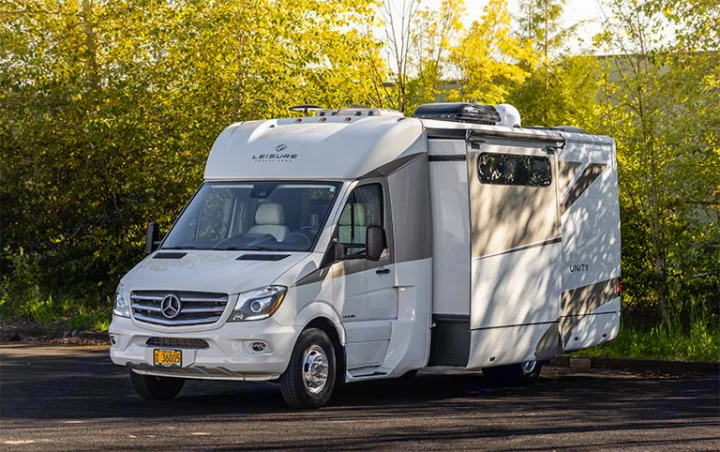 White Mercedes-Benz Leisure Travel Unity RV for rv rental, parked on asphalt.. Leisure Travel Vans Unity 2016