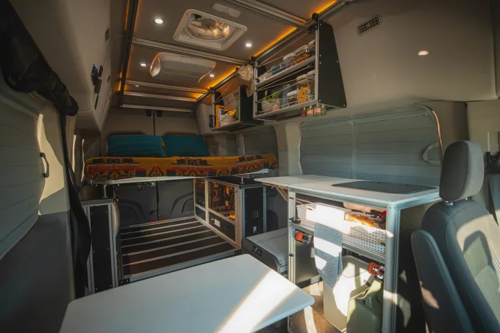 Cozy & fully-equipped rv rental interior with bed, kitchen, storage, and power system for comfortable travels.. Vandoit LIV 2019