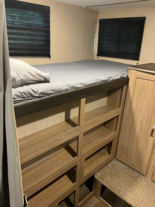 Cozy RV rental bunk bed area with ample built-in shelves and wardrobe storage.. Coachmen Freedom Express Ultra Lite 292BHDS 2021