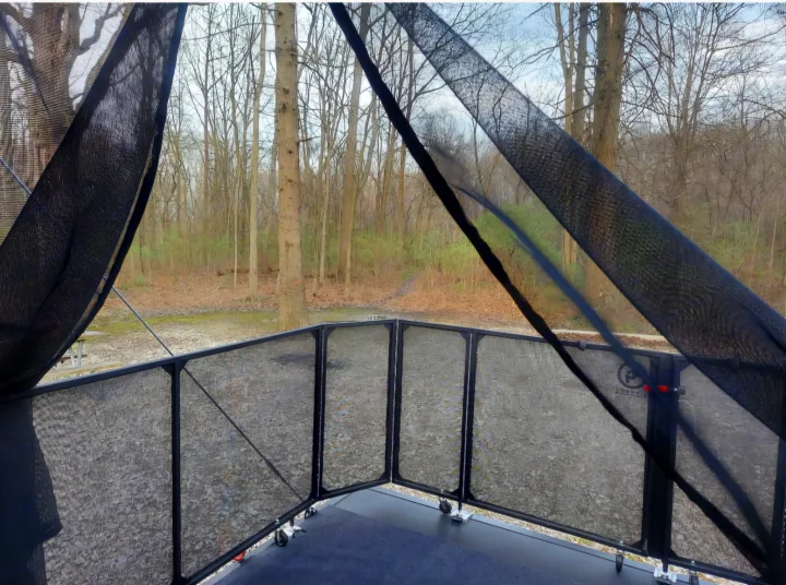 Enjoy nature from your RV rental's spacious screened-in patio deck, overlooking a wooded path and gravel campsite.. Forest River Salem 2022