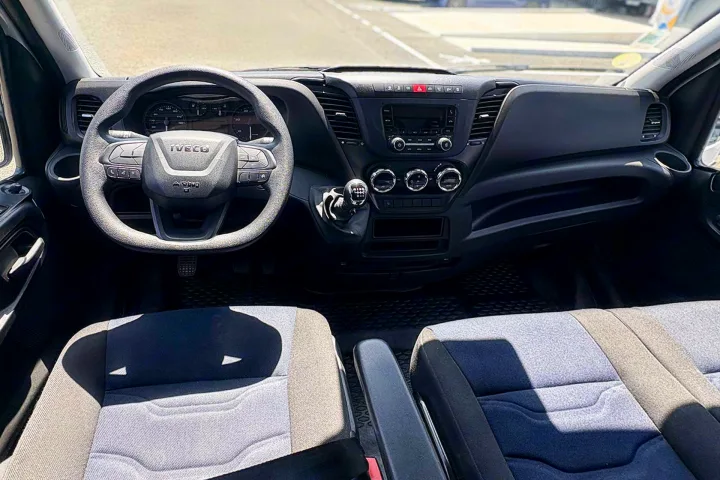 Spacious Iveco vehicle interior, showing dashboard, steering wheel, and front seats—ready for your next rv rental adventure.. IVECO 35C16 2023