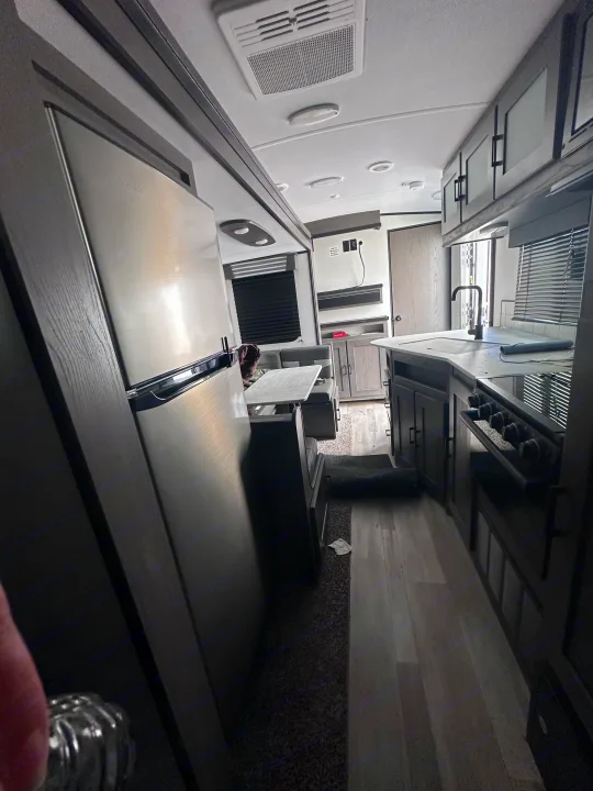 Modern rv rental interior features a full kitchen with sink/stove, large fridge, and a comfortable dinette area.. MPG Cruiser RV ultra light 2500 2021