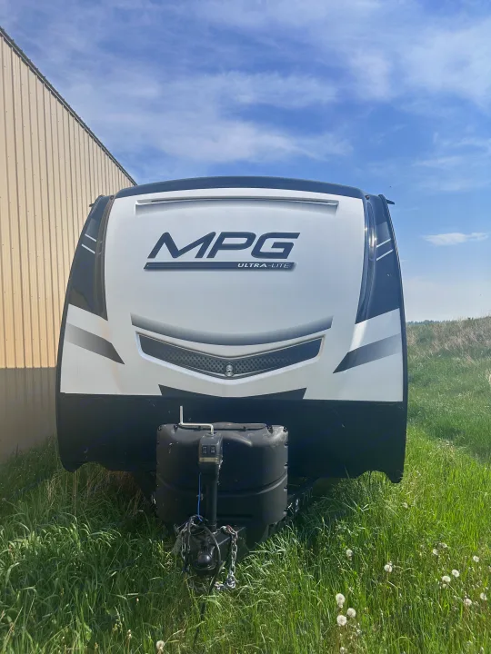 A white MPG Ultra-Lite travel trailer, perfect for an RV rental, parked on grass under a blue sky.. MPG Cruiser RV ultra light 2500 2021