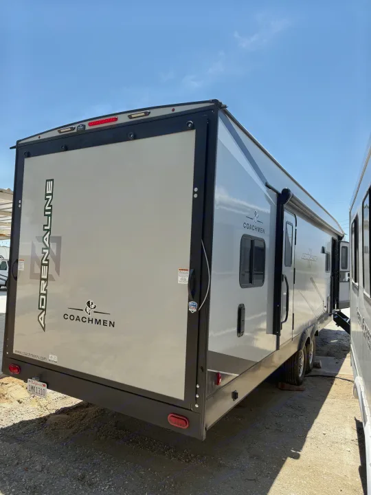 This spacious grey Coachmen Adrenaline RV rental is a toy hauler travel trailer with a California plate, ready for adventure.. Coachmen Adrenaline 2025